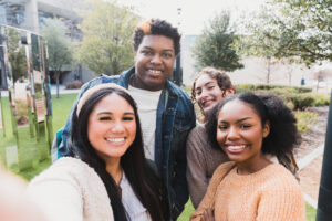 Happy Multiracial College Students Taking a Selfie Outdoors